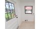 Bright laundry area with access to outside; features tile flooring and hookups for appliances at 4469 Evers Pl, Orlando, FL 32811