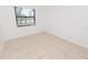 Bright living room with tiled floors and a large window allowing for abundant natural light at 4469 Evers Pl, Orlando, FL 32811