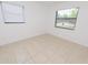 Bright living room with tiled floors and two windows allowing for abundant natural light at 4469 Evers Pl, Orlando, FL 32811