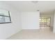 Spacious living room features tile flooring, ample natural light, and an open layout leading to the sunroom at 4469 Evers Pl, Orlando, FL 32811