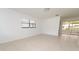 Spacious living room features tile flooring, ample natural light, and an open layout leading to the sunroom at 4469 Evers Pl, Orlando, FL 32811