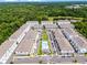 Sprawling aerial view of a neighborhood with ponds, lush trees, and townhomes at 461 Diamond Dove Cv, Winter Springs, FL 32708