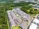 High angle view of a neighborhood, with lots of trees, townhomes, and a pool at 461 Diamond Dove Cv, Winter Springs, FL 32708