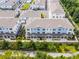 Aerial view of residential townhomes community and neighborhood featuring a pool and green landscaping at 461 Diamond Dove Cv, Winter Springs, FL 32708