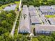 Aerial view of blue and white townhomes in a neighborhood with a nearby pond and lush trees at 461 Diamond Dove Cv, Winter Springs, FL 32708