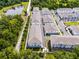 Aerial view of townhome community featuring lush landscaping, walking paths, and a tranquil pond at 461 Diamond Dove Cv, Winter Springs, FL 32708
