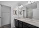 Bathroom featuring a double vanity with framed mirrors and a view into the glass-enclosed shower at 461 Diamond Dove Cv, Winter Springs, FL 32708