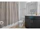 Modern bathroom with a shower, dark vanity, and sleek, neutral-toned finishes at 461 Diamond Dove Cv, Winter Springs, FL 32708