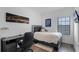 Cozy bedroom with a desk, decorative rug, and a window providing natural light at 461 Diamond Dove Cv, Winter Springs, FL 32708