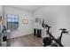 The bedroom features hardwood floors, a peloton bike, and great natural lighting at 461 Diamond Dove Cv, Winter Springs, FL 32708