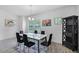 Elegant dining room with a modern table, stylish chairs, natural light, and modern decor at 461 Diamond Dove Cv, Winter Springs, FL 32708