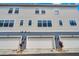 Multi-story home with garage doors, windows, and exterior lighting at 461 Diamond Dove Cv, Winter Springs, FL 32708