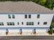 Aerial view of townhome garages featuring two stories with grey siding and dark trim windows at 461 Diamond Dove Cv, Winter Springs, FL 32708