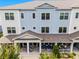 Three-story townhouse featuring a covered front porch, blue siding, and white trim at 461 Diamond Dove Cv, Winter Springs, FL 32708