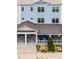 Three-story townhouse showcasing the blue siding and covered front porch at 461 Diamond Dove Cv, Winter Springs, FL 32708