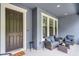 Covered front porch with outdoor seating at 461 Diamond Dove Cv, Winter Springs, FL 32708