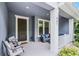 Close-up view of the cozy front porch with elegant seating at 461 Diamond Dove Cv, Winter Springs, FL 32708