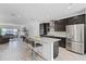 Bright kitchen with modern appliances, granite countertops, an island with seating, and an open floor plan at 461 Diamond Dove Cv, Winter Springs, FL 32708