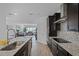 Open-concept kitchen with granite countertops, stainless steel appliances, and easy access to the living room at 461 Diamond Dove Cv, Winter Springs, FL 32708