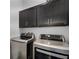 Modern laundry room with front load washer and dryer, and upper cabinets at 461 Diamond Dove Cv, Winter Springs, FL 32708