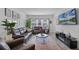 Spacious living room with a plush leather sofa, modern decor, and plenty of natural light at 461 Diamond Dove Cv, Winter Springs, FL 32708