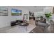 Bright living room featuring stylish furnishings, a large flat-screen TV, and an open layout concept at 461 Diamond Dove Cv, Winter Springs, FL 32708