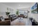 Inviting living room featuring a comfortable sofa, modern decor, and a large flat-screen TV at 461 Diamond Dove Cv, Winter Springs, FL 32708