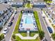 Aerial view of community pool and lounge area surrounded by townhomes and palm trees at 461 Diamond Dove Cv, Winter Springs, FL 32708