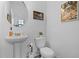 Elegant powder room with white fixtures, bright lighting, and classic decor at 461 Diamond Dove Cv, Winter Springs, FL 32708