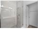 Bright glass-enclosed shower stall in the bathroom with gray tile and a view into the bathroom at 461 Diamond Dove Cv, Winter Springs, FL 32708