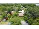 Aerial view of home featuring a lush lawn surrounded by mature trees, creating a serene environment at 4757 Goldsboro Ct, Orlando, FL 32811