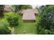 Aerial view of a charming single-story home with a well-maintained lawn and mature trees at 4757 Goldsboro Ct, Orlando, FL 32811