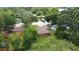 Aerial view of home with a quaint, green lawn and carport, nestled in a verdant, established neighborhood at 4757 Goldsboro Ct, Orlando, FL 32811