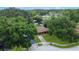 Aerial view of a landscaped property with a brown roof surrounded by mature trees at 4757 Goldsboro Ct, Orlando, FL 32811