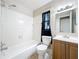 Bathroom with tub and shower, classic vanity, and tiled walls at 4757 Goldsboro Ct, Orlando, FL 32811