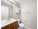 Bathroom featuring a vanity with a wooden cabinet, a toilet, and a mirror at 4757 Goldsboro Ct, Orlando, FL 32811