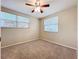 Neutral bedroom featuring a ceiling fan, carpet floors, and two windows at 4757 Goldsboro Ct, Orlando, FL 32811