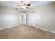 Bedroom with ceiling fan, bi-fold closet doors, and tile flooring at 4757 Goldsboro Ct, Orlando, FL 32811