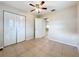 Bedroom with a ceiling fan and closet offers tile flooring and natural light at 4757 Goldsboro Ct, Orlando, FL 32811