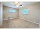 Bedroom features tile flooring, two windows, and ceiling fan at 4757 Goldsboro Ct, Orlando, FL 32811