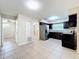 Well-lit kitchen with stainless steel refrigerator and tile flooring at 4757 Goldsboro Ct, Orlando, FL 32811