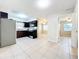 Open kitchen with modern appliances and granite countertops overlooks the dining and living areas at 4757 Goldsboro Ct, Orlando, FL 32811