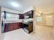 Well-equipped kitchen with a stainless steel oven and dark cabinets at 4757 Goldsboro Ct, Orlando, FL 32811