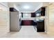 Bright kitchen featuring tile floors, modern appliances and stylish dark wood cabinets at 4757 Goldsboro Ct, Orlando, FL 32811