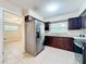 Kitchen features tile floors, stainless steel appliances, and dark wood cabinets at 4757 Goldsboro Ct, Orlando, FL 32811