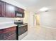 Kitchen featuring tile floors, stylish dark wood cabinets and modern appliances at 4757 Goldsboro Ct, Orlando, FL 32811