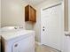 Laundry area featuring a washing machine, a hanging cabinet, and a door at 4757 Goldsboro Ct, Orlando, FL 32811