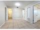Spacious living room with neutral walls, tile floors, and access to multiple rooms at 4757 Goldsboro Ct, Orlando, FL 32811