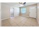 Living room with tile flooring, a ceiling fan, and a welcoming front door at 4757 Goldsboro Ct, Orlando, FL 32811