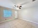 Bright living room with tile floors and a ceiling fan at 4757 Goldsboro Ct, Orlando, FL 32811